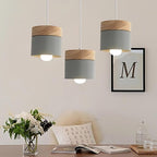 Clérachic grey pendant lights, three hung above a desk with flowers, books and a framed letter print.