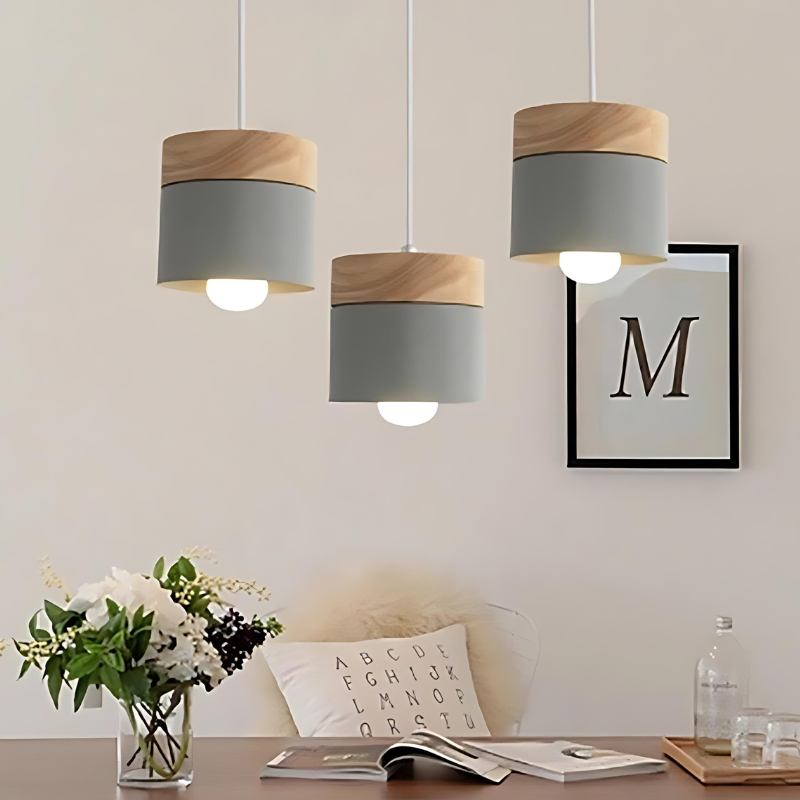 Clérachic grey pendant lights, three hung above a desk with flowers, books and a framed letter print.