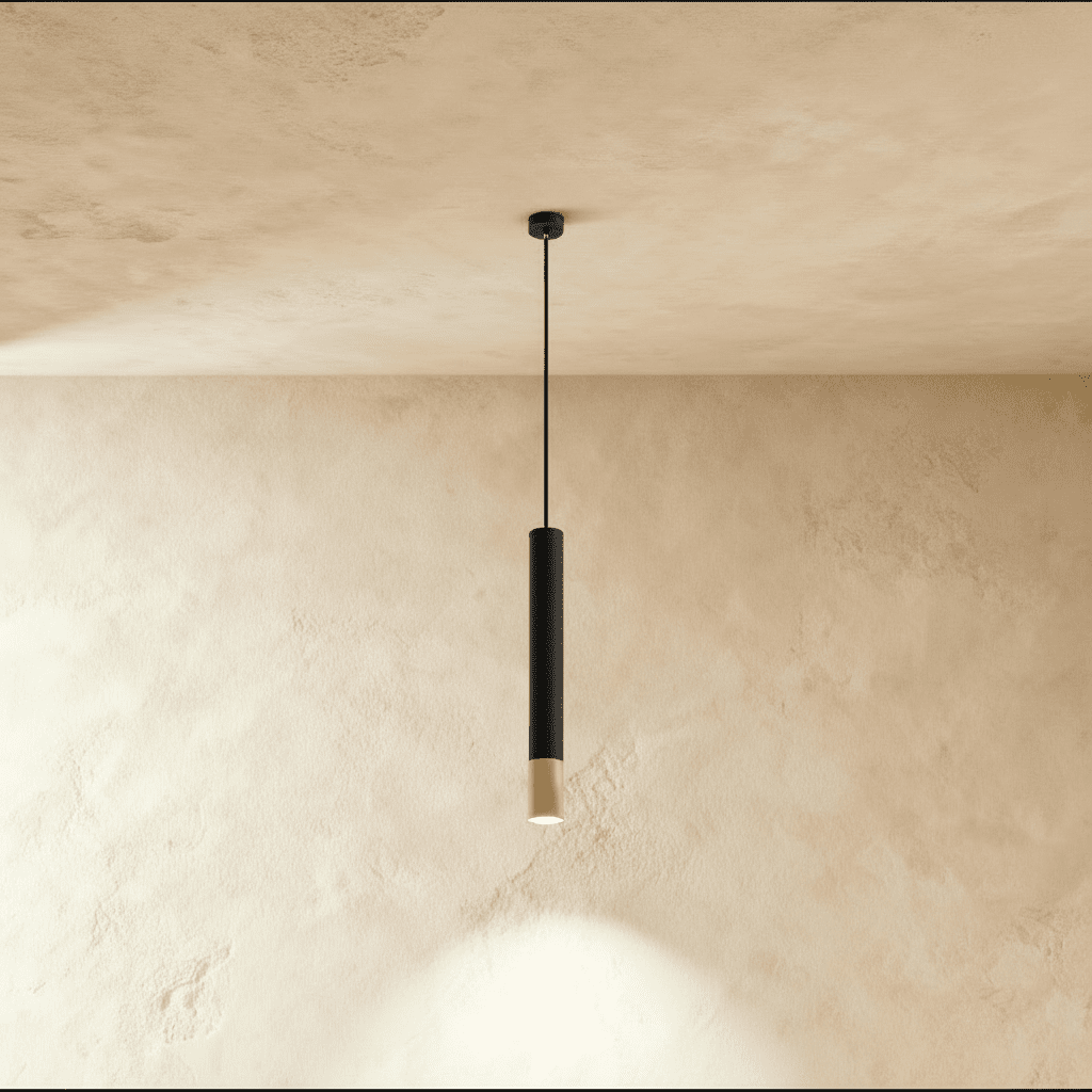 Clérachic black pendant light with a gold rim accent hangs on a slim cord against a warm plaster ceiling.