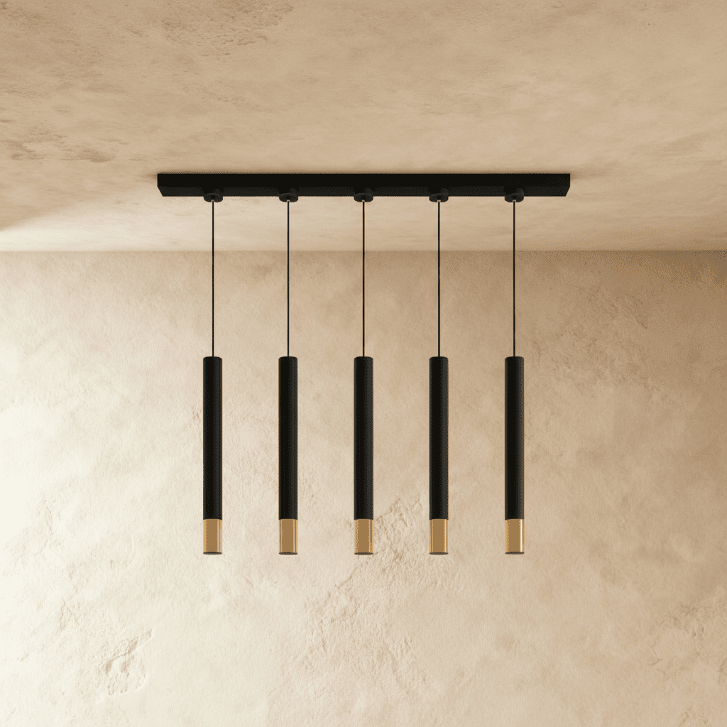 Clérachic linear five-pendant fixture, black cylinders with gold rims, shown against a warm plaster backdrop.