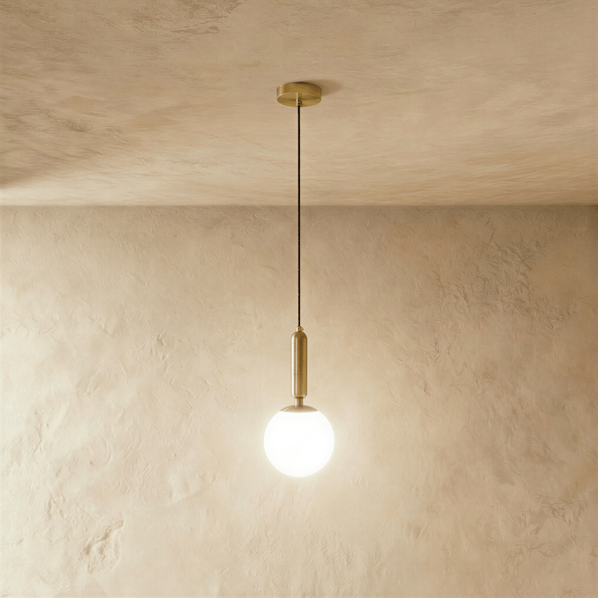 Clérachic brass pendant light with a glowing white globe shade, suspended from a round brass ceiling canopy.