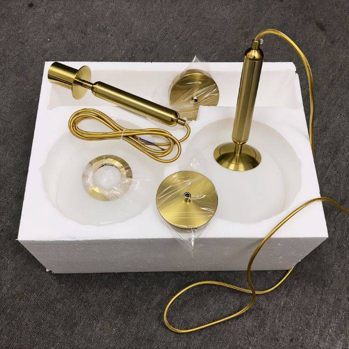 Clérachic pendant light packaged in a foam-lined box with brass fittings, cord and wrapped white glass globes.