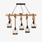 A five-head Clérachic pendant light on a white backdrop, with black iron mesh cages hanging on knotted hemp rope from a wooden beam.