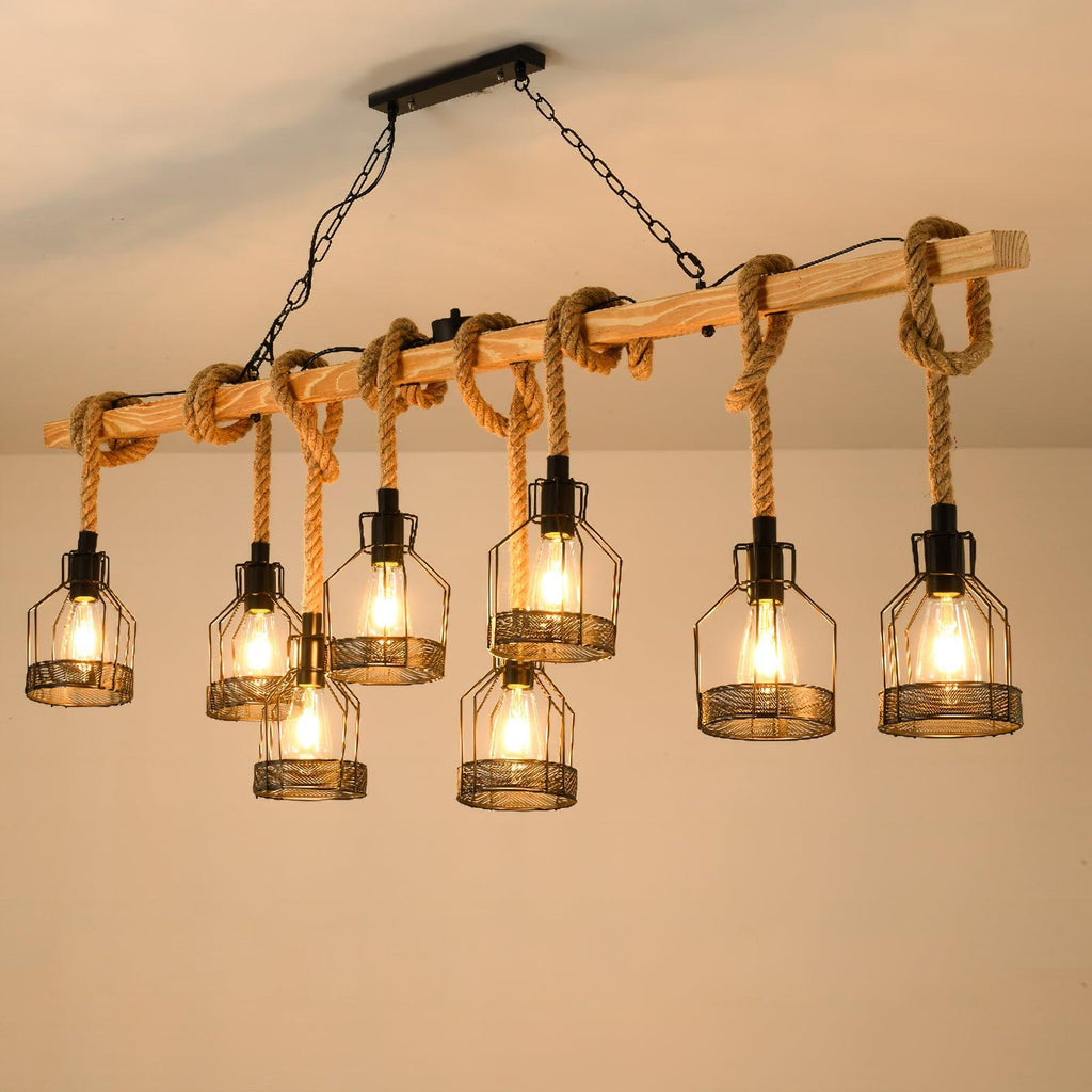 A longer Clérachic pendant light with more heads, lit warmly under a cream ceiling on a wooden beam with knotted rope.