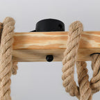 Close view of the knotted hemp rope, the pine beam and the black canopy fixing on this Clérachic pendant light.