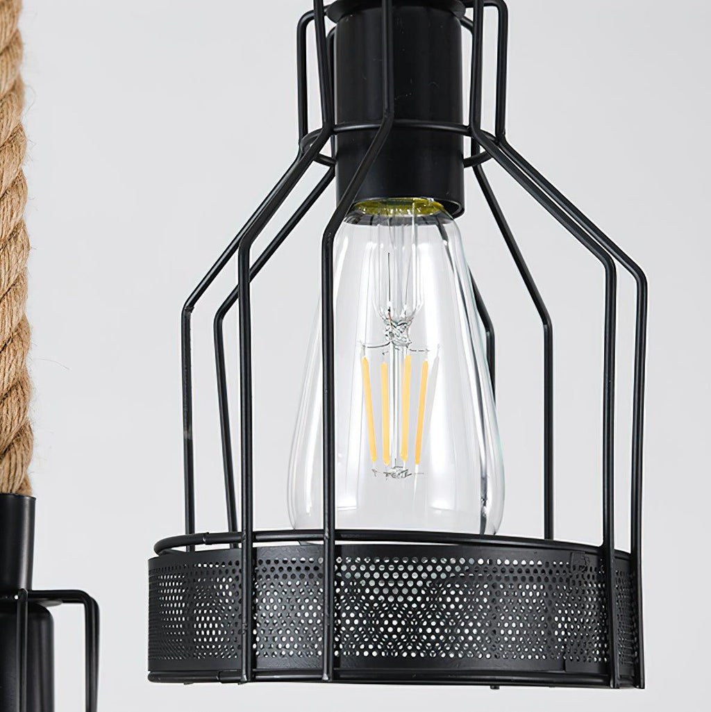Close view of a black iron mesh cage with an exposed clear filament bulb on this Clérachic pendant light.