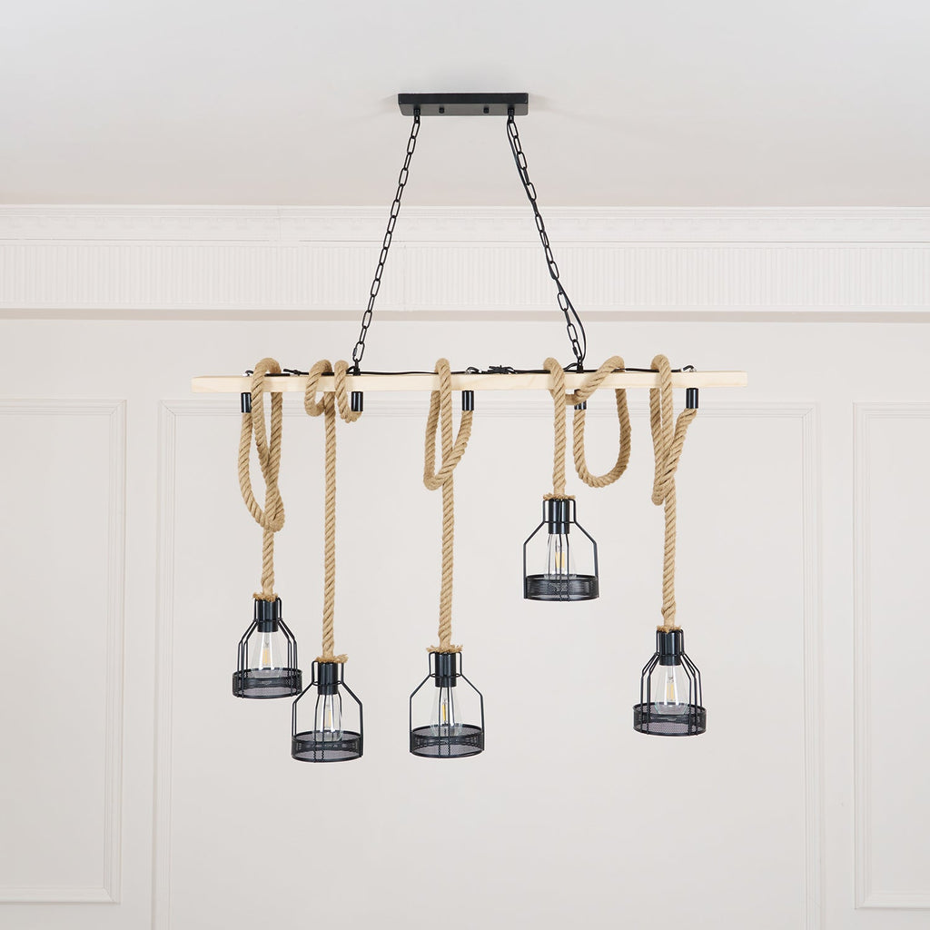 A pale-beam Clérachic pendant light with five rope-hung cages, shown from a slightly lower angle in a white room.