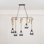 A pale-beam Clérachic pendant light with five rope-hung cages, shown from a slightly lower angle in a white room.