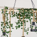 Close view of green leaf garland wound through the hemp rope and beam of this Clérachic pendant light.