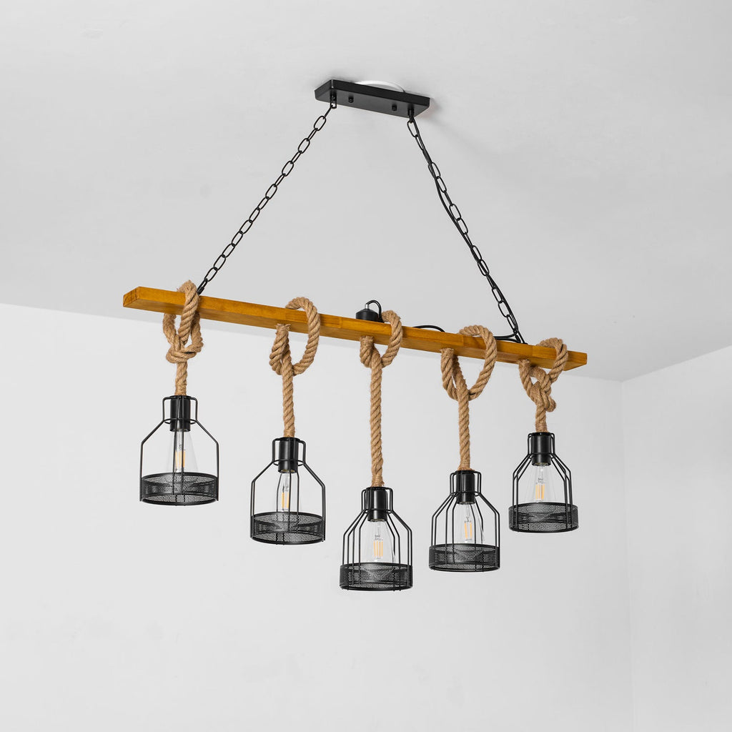 Clérachic pendant light with five caged bulbs, seen from below against a white wall and ceiling corner.