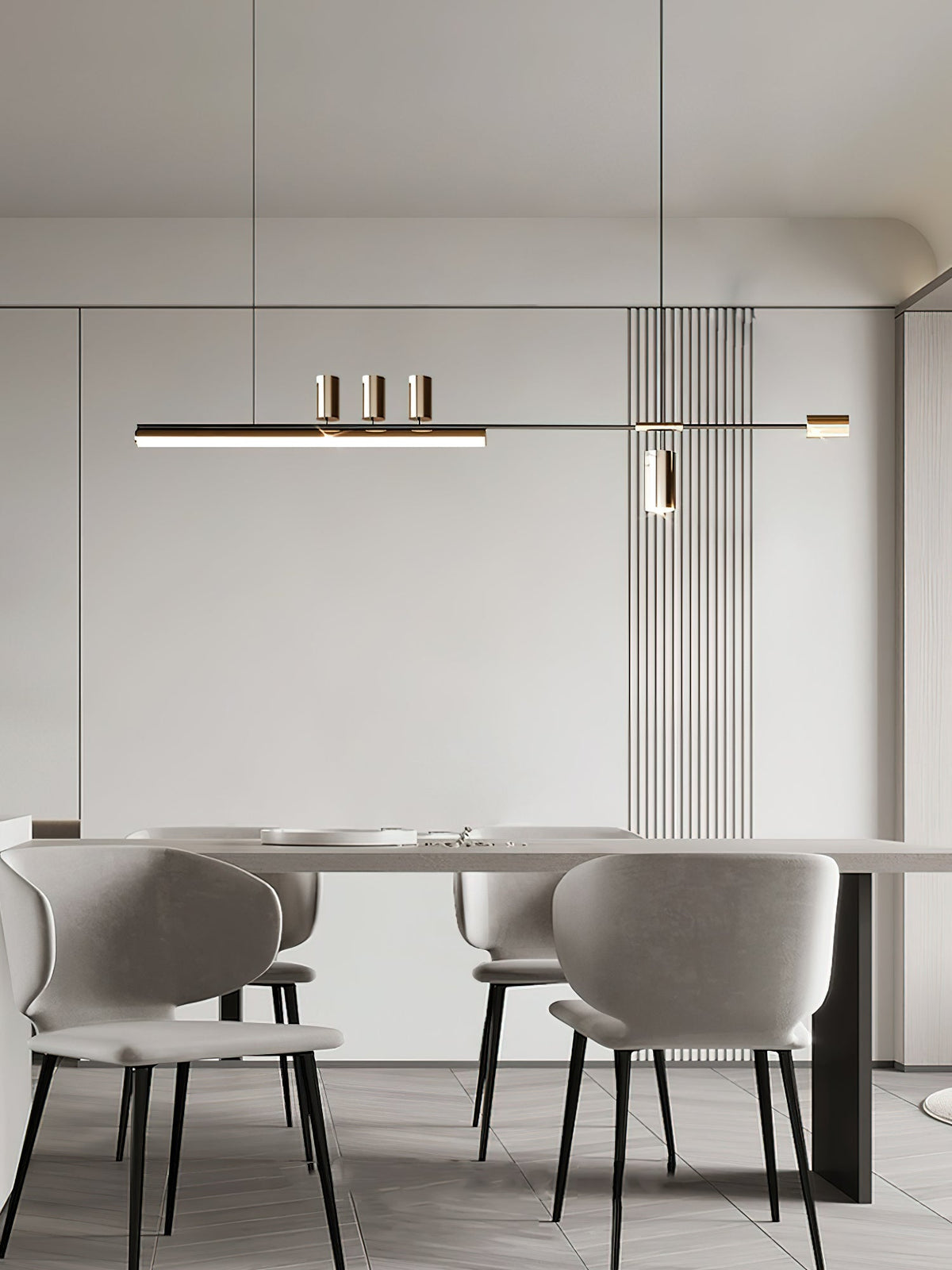 This Clérachic pendant hangs in a pale dining room, centred over a long table with grey upholstered chairs.
