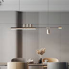 Horizontal LED pendant from Clérachic against vertical wood-slat panelling, with soft chairs and pampas stems on the table.