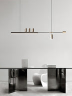 This Clérachic pendant hangs over a glossy dark-based table with a white sculptural chair and a laptop on top.