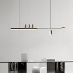 Bar pendant from Clérachic above a glass-topped table with a white moulded chair and a laptop, against a plain grey wall.