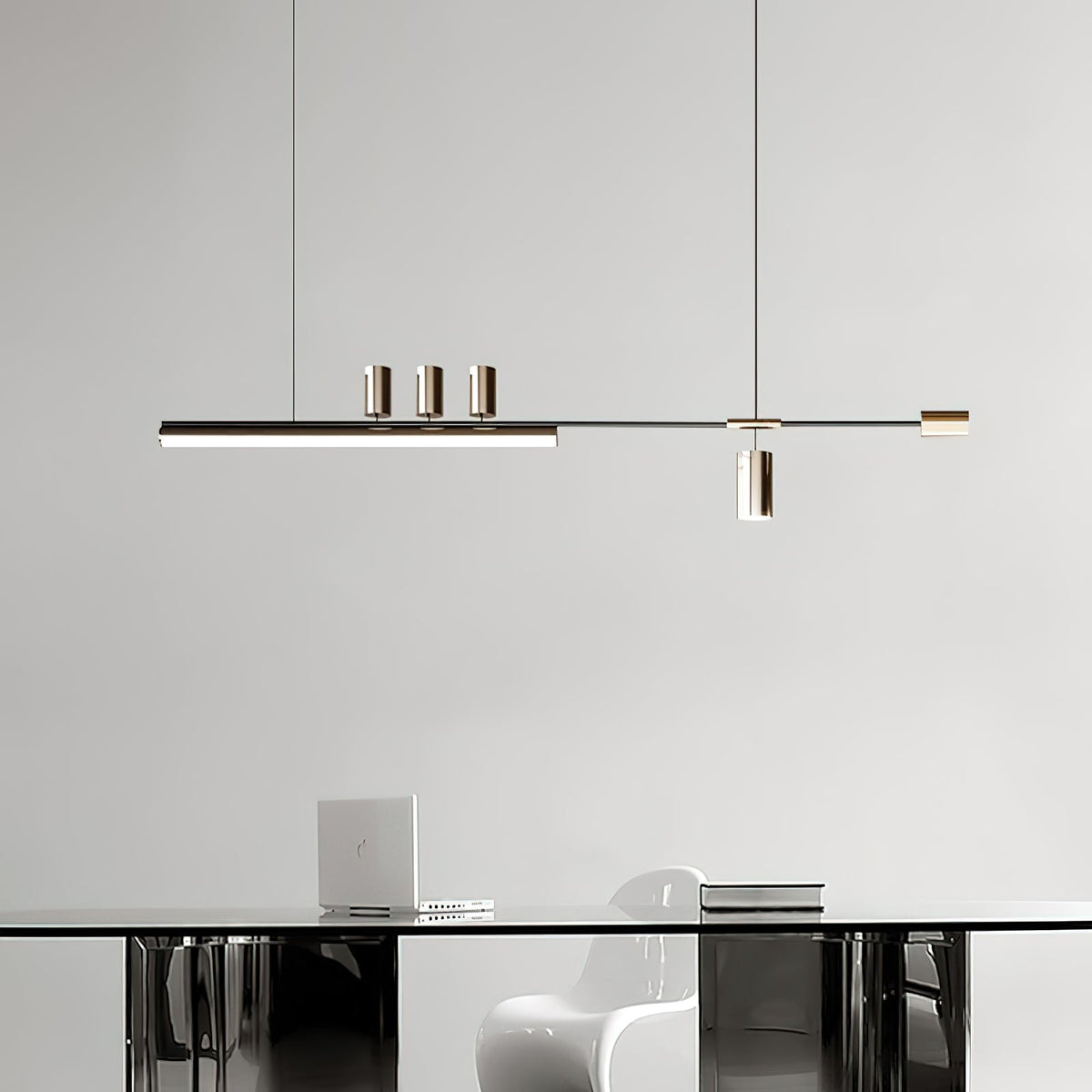Bar pendant from Clérachic above a glass-topped table with a white moulded chair and a laptop, against a plain grey wall.