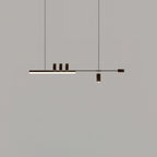 Distant view of this Clérachic pendant on a mid-grey backdrop, its bar lit and the end cap and cylinders in a dark finish.