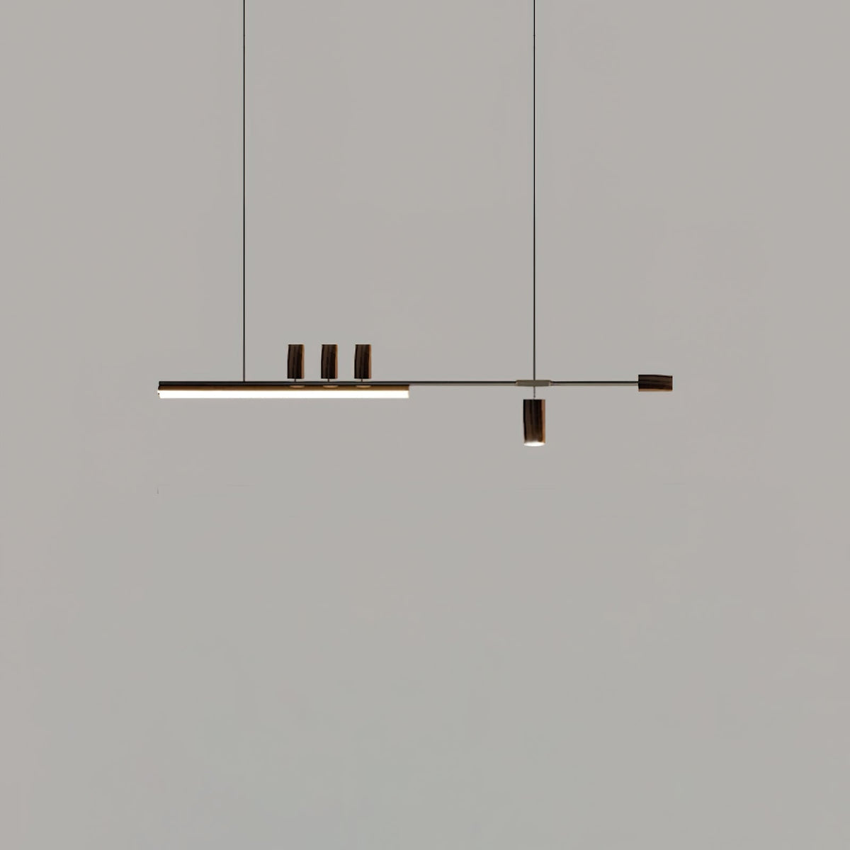 Distant view of this Clérachic pendant on a mid-grey backdrop, its bar lit and the end cap and cylinders in a dark finish.
