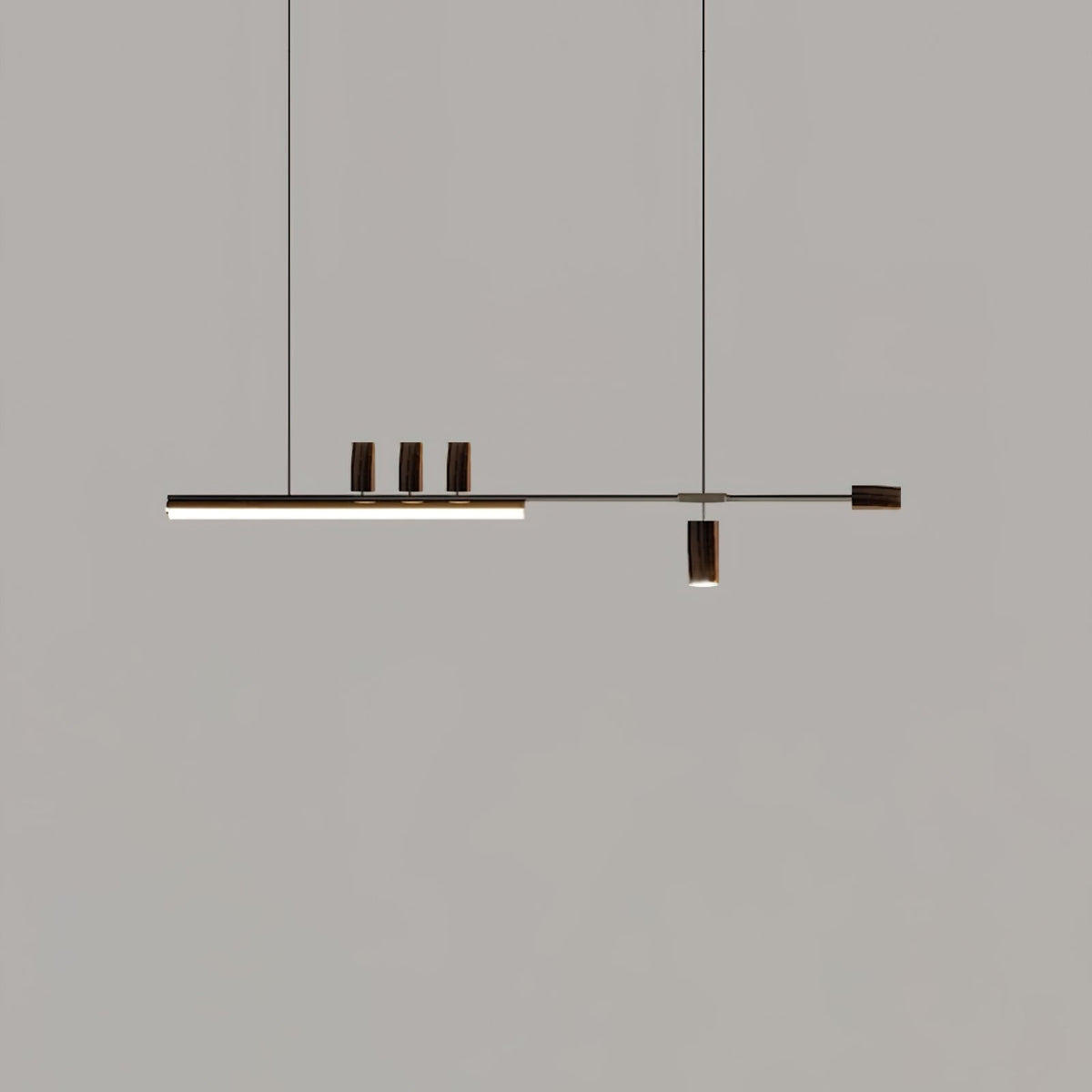 Dark-ended version of this Clérachic pendant against a grey backdrop, its bar lit and three dark cylinders on top.