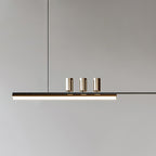 Close view of the three cylinder heads and the lit underside of the bar on this Clérachic pendant.