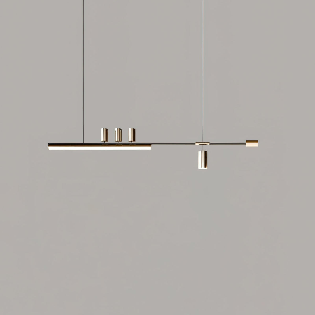 Slim LED bar pendant from Clérachic on a grey backdrop, shown smaller in frame with its cylinders in a soft metal tone.