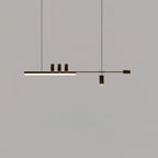 Another dark-toned view of this Clérachic pendant on grey, with the bar lit and the top cylinders and end cap in deep brown.