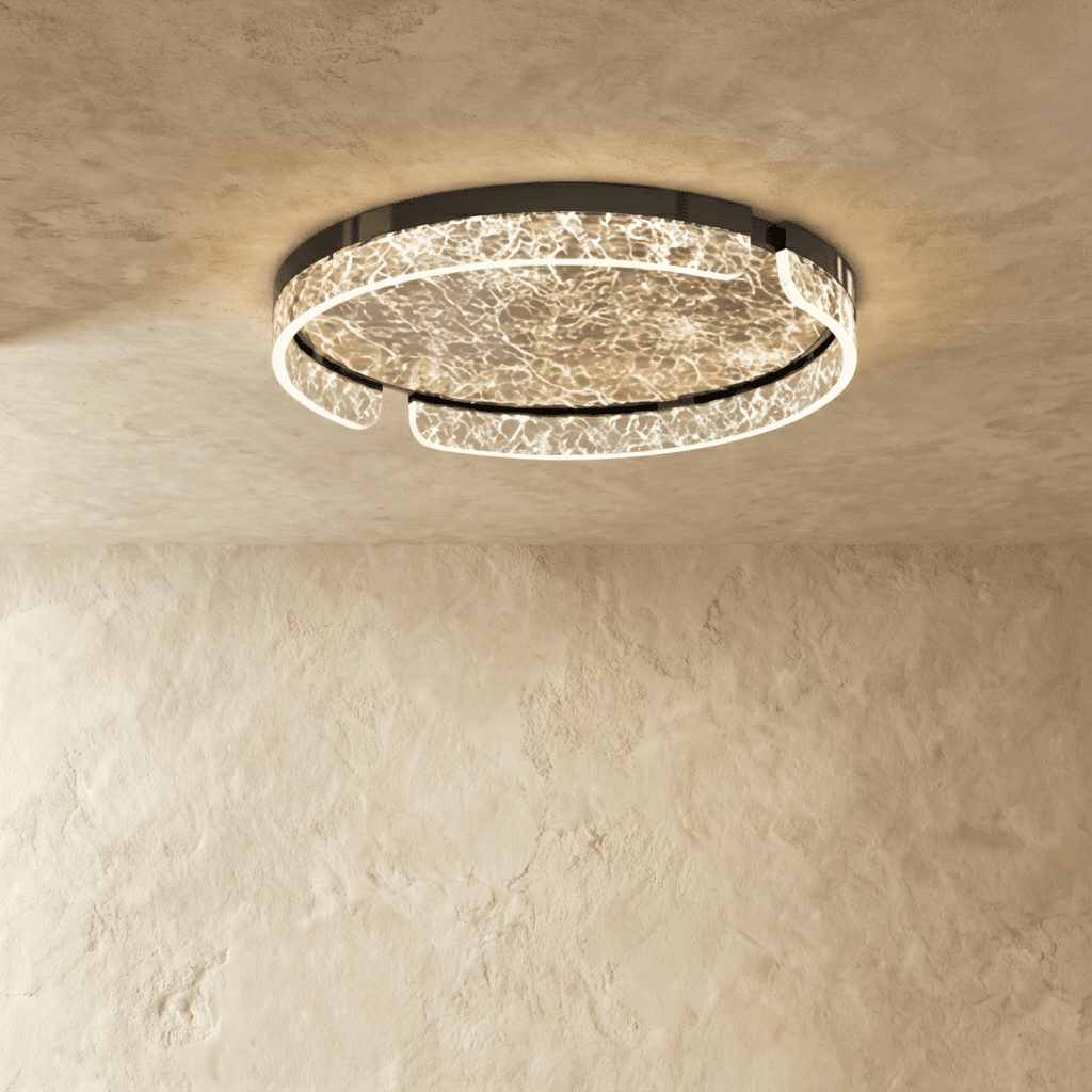 Clérachic round ceiling light with a black metal frame and a lit marbled glass ring, seen against a textured plaster ceiling.