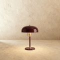 Clérachic dome table lamp in red enamel with a brass neck and base ring, photographed straight-on against a plain backdrop.