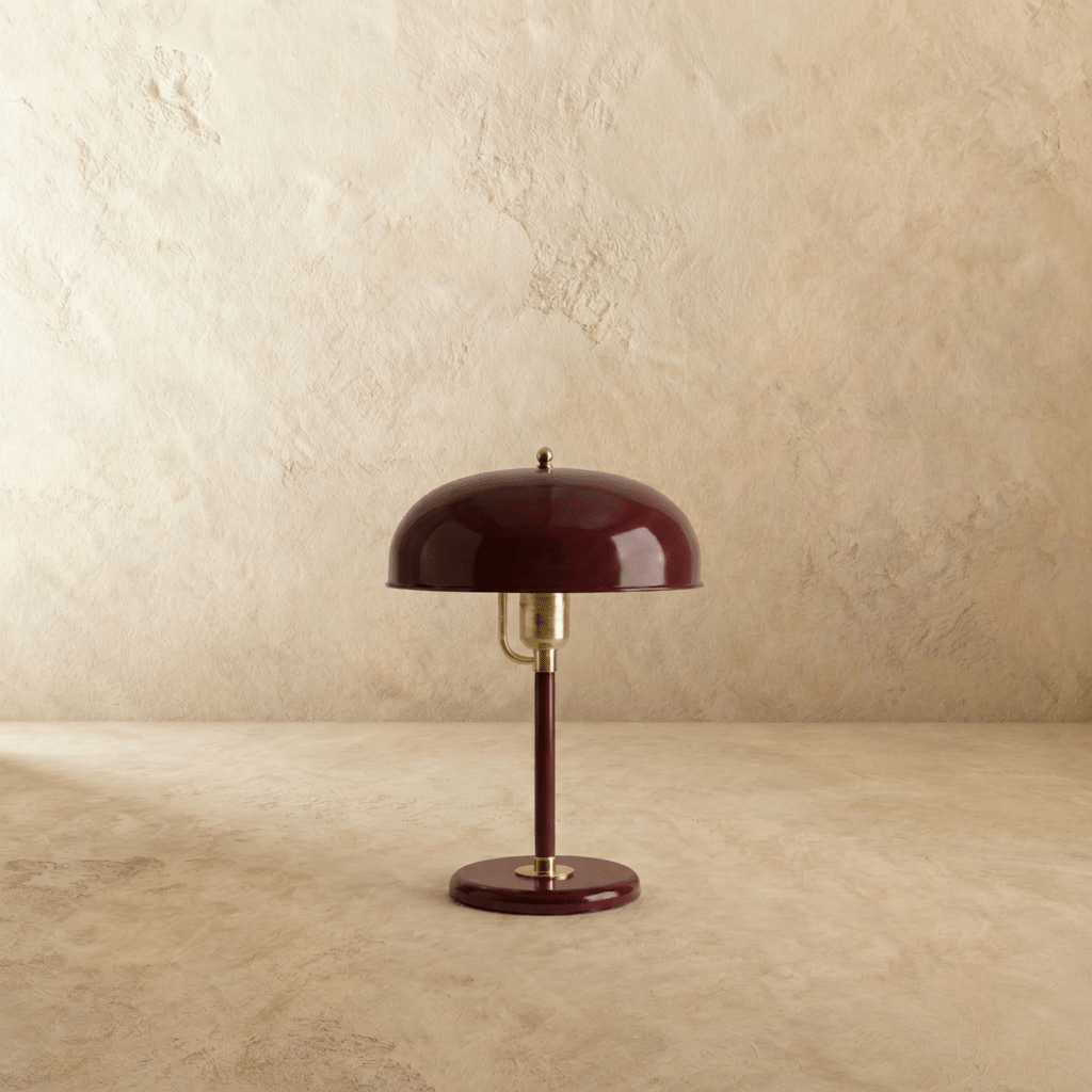 Clérachic dome table lamp in red enamel with chrome fittings, shown from a slight angle against a plain studio backdrop.