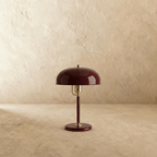 Clérachic dome table lamp in red enamel with chrome fittings, shown from a slight angle against a plain studio backdrop.