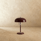 Clérachic dome table lamp in red enamel with chrome fittings, shown closer-cropped against a plain studio backdrop.