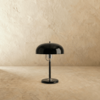 Clérachic dome table lamp in glossy black enamel with chrome fittings, shown closer-cropped against a plain backdrop.