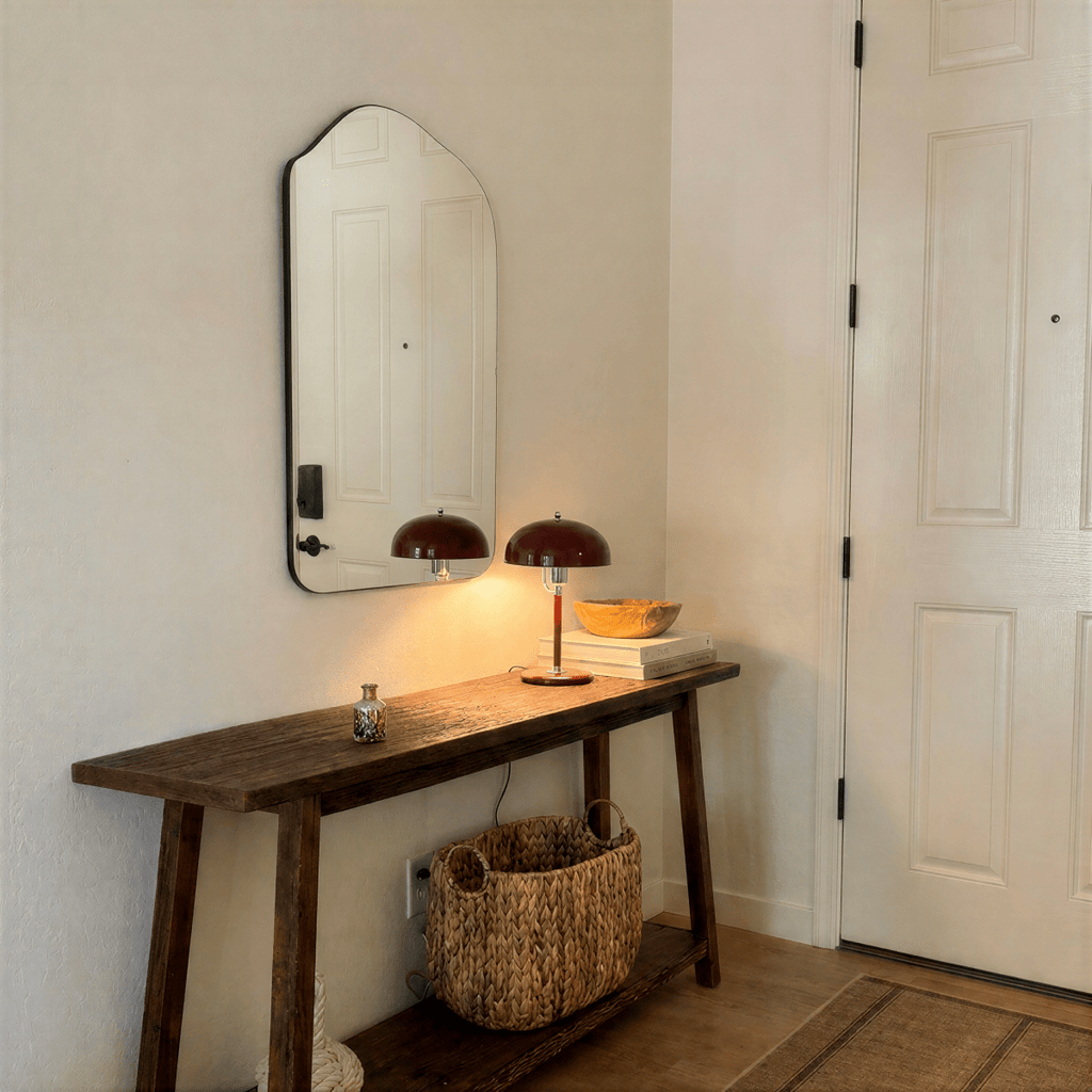Clérachic red dome table lamp with chrome fittings lit on a wooden console table beneath a mirror in an entryway.