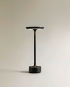 Clérachic's black cordless table lamp stands tall on a round base, its stem rising to a saucer shade.
