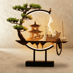 Clérachic incense-burner lamp lit warm, a standing white figure before a pagoda inside the glowing ring.