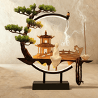 Clérachic incense-burner lamp, a standing white figure beside a pagoda inside a ring glowing at its base.