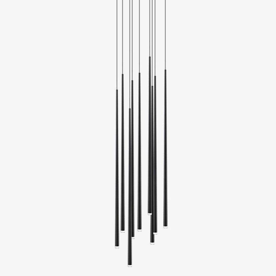 Cluster of slim black tapered tube pendants hanging at staggered heights against a plain white backdrop, from Clérachic.