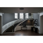 Wide hallway with a curved white-panelled staircase and a small black-canopy Clérachic pendant cluster hanging in the centre.