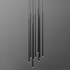 Dense cluster of long black needle pendants at uneven heights, tips lit, against a grey gradient backdrop, from Clérachic.