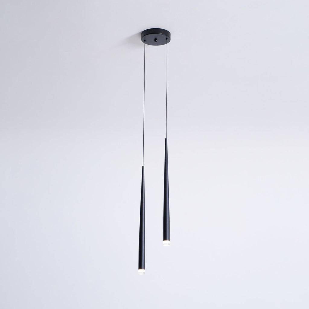 Slim two-light black pendant from a small round canopy, one tube longer than the other, with glowing tips, a Clérachic pendant.