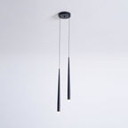 Slim two-light black pendant from a small round canopy, one tube longer than the other, with glowing tips, a Clérachic pendant.