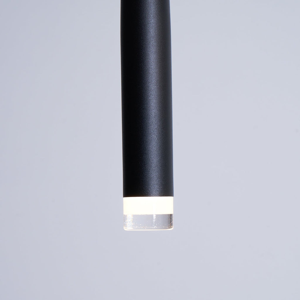 Close view of the matte black tube end and the frosted ring around the LED on this Clérachic pendant.