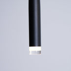 Close view of the matte black tube end and the frosted ring around the LED on this Clérachic pendant.