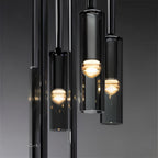 A cluster of black-tinted glass pendants glows warm in close-up against a dark gradient backdrop, Clérachic detail shot.