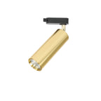 A gold cylindrical Clérachic track spotlight with a black adaptor, tilted to show the recessed lens, on white.