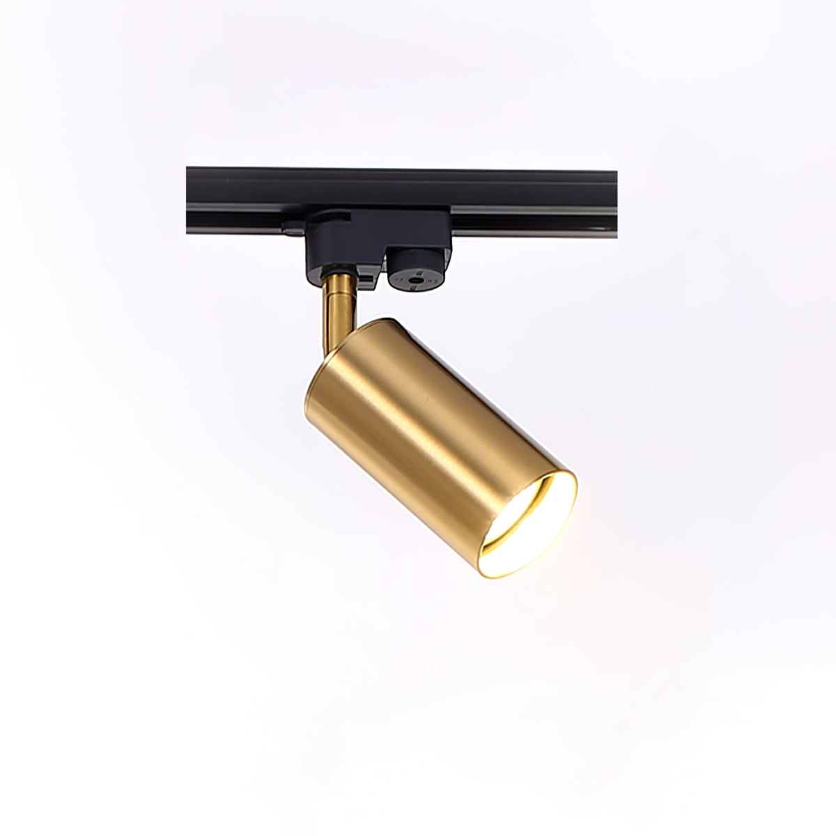 Gold cylindrical Clérachic spotlight on a black track section, tilted down to show its open lens.