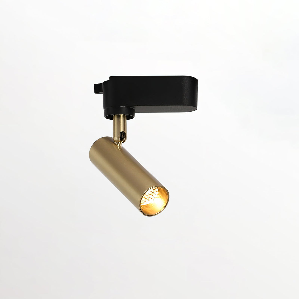 Single gold Clérachic spotlight on a slim stem with a black adaptor, lit and tilted on a plain background.