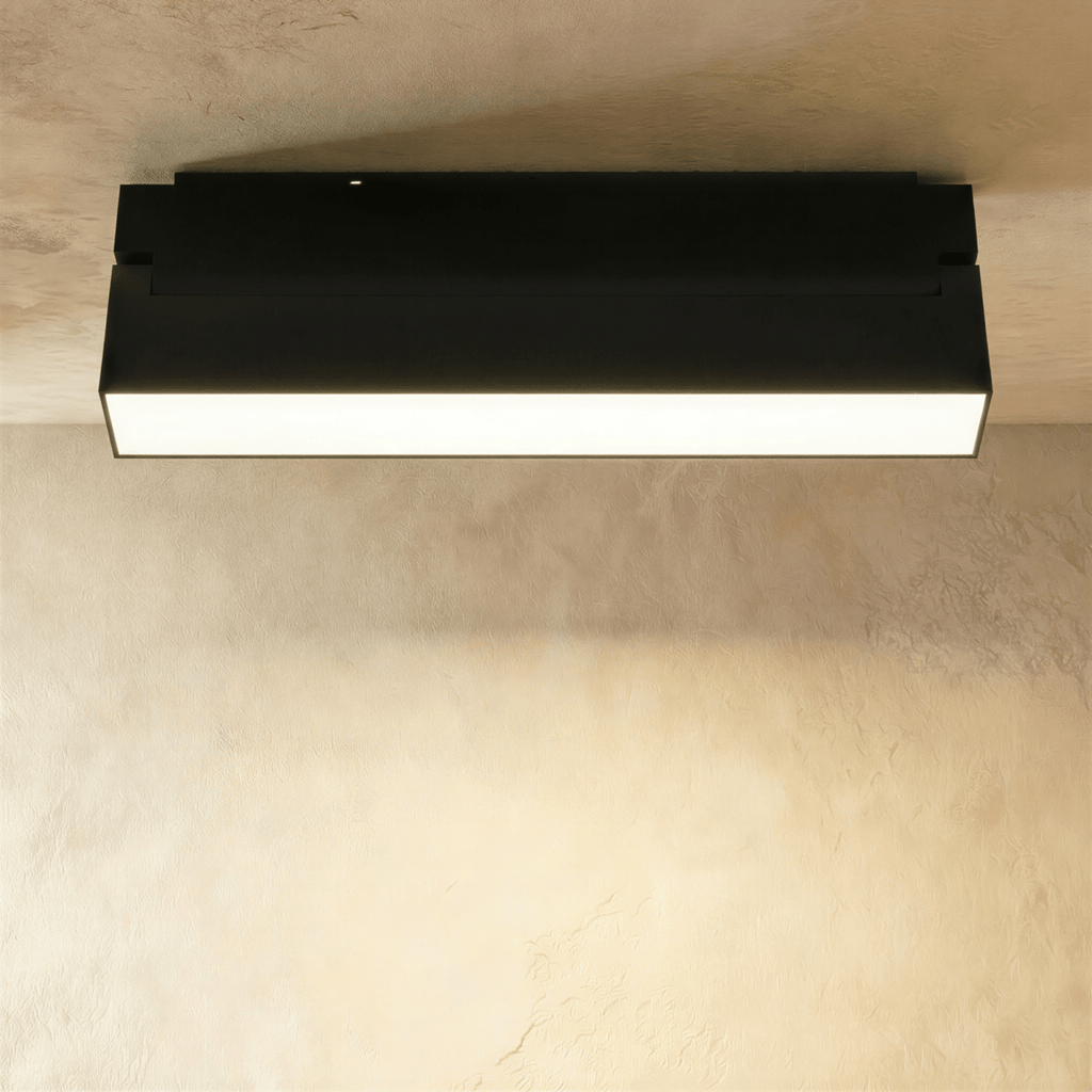 Clérachic short black linear floodlight with a frosted diffuser strip, mounted flush to a ceiling track rail.