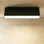 Clérachic short black linear floodlight with a frosted diffuser strip, mounted flush to a ceiling track rail.