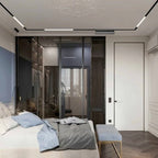 Clérachic recessed-look linear track lighting installed above a bedroom closet, framing sliding glass wardrobe doors.