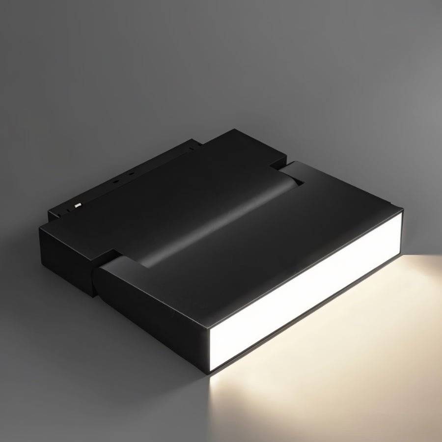 Clérachic black rectangular floodlight fixture angled to show its bright frosted lens against a grey backdrop.